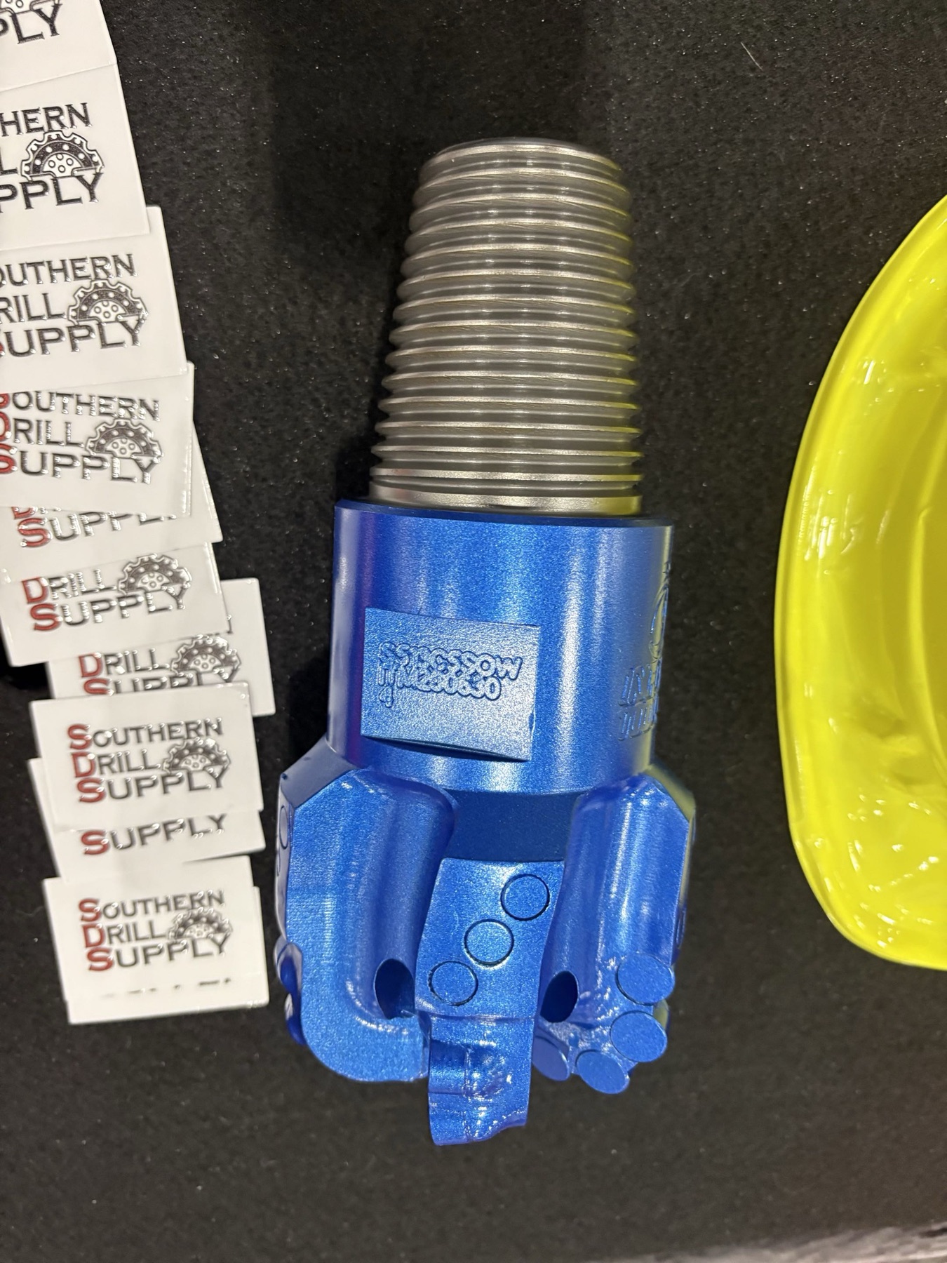 Blue drill bit displayed at the Southern Drill Supply booth